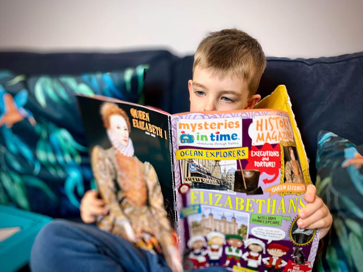 Boy reading Mysteries in Time history magazine